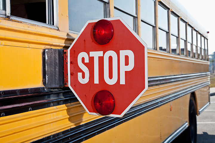 how does a school bus stop sign work